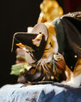 Close-up of cat wearing steampunk witch hat details