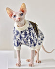 Hairless cat in mohair knit sweater, side profile showing turtleneck fit