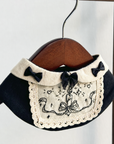 Halloween cosplay bib with embroidered candle motif and fabric bow details